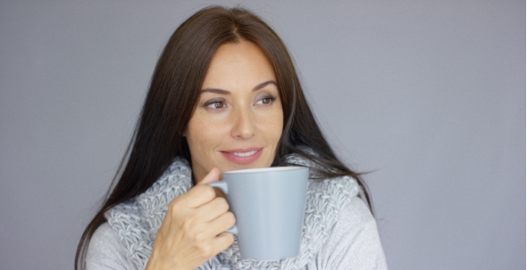 Beautiful Brunette Woman With a Cup Of Hot Drink alt
