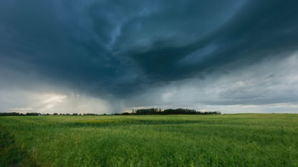 Dramatic Storm Clouds Roll Across Field With Light Beams Shining ...