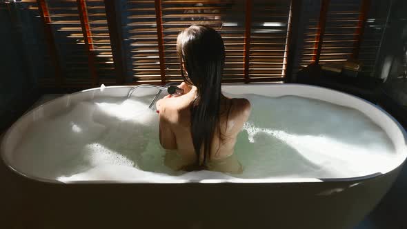 Sexy Woman Taking Bathtub with Bubbles at Home Relaxing and Spa in Luxury Hotel alt