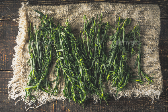 Tarragon on the canvas on the wooden table top view