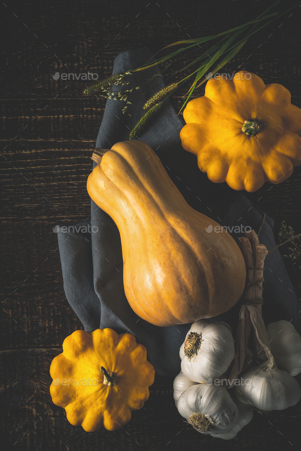 Pumpkin , patty pans and garlic on the old wooden table top view