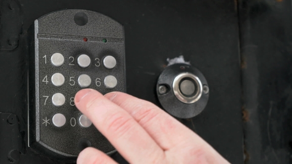 Hand Dials Number Of Apartment On Intercom System