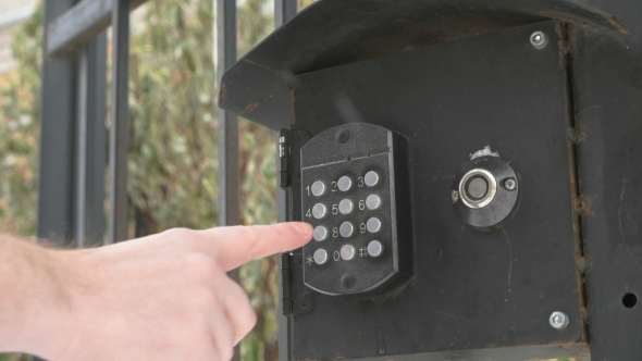 Person Push Buttons On a Panel Of Intercom System