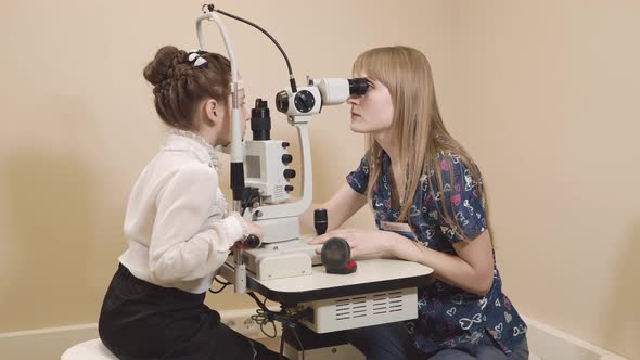 Doctor Is Engaged in Biomicroscopy of the Eye He Checks His Eyes for Illnesses alt