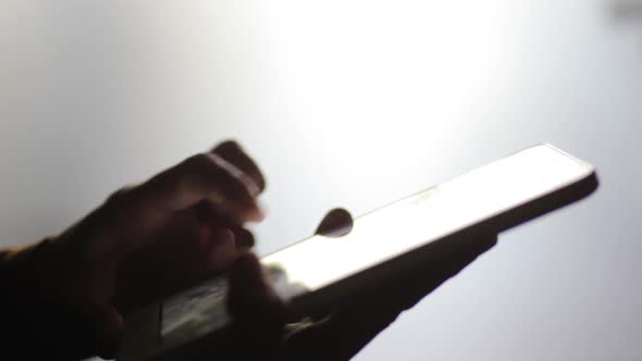 Person's hands using a tablet