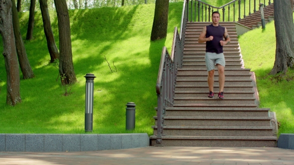 Young Man Running Down Stairs. Healthy Lifestyle Concept alt