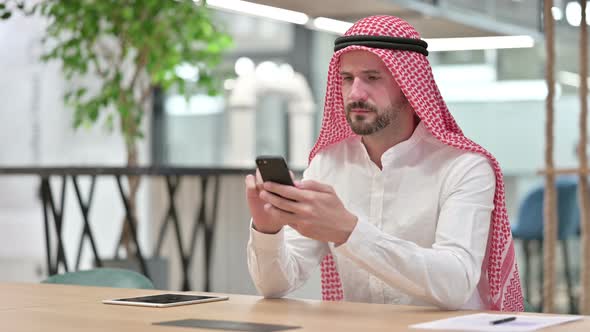 Arab Businessman Using Smartphone, Text Messaging alt