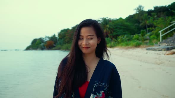 Cute Smiling Asian Girl in Kimono Walking on a Beach in Slow Motion Thailand