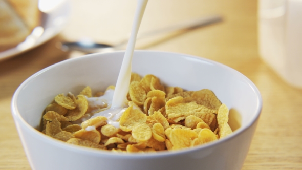 Pouring Milk Into a Bowl With Corn Flakes, Stock Footage | VideoHive
