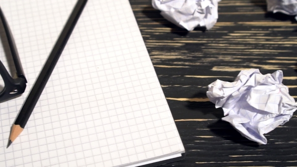 Person Throwing a Lot Of Crumpled Paper On a Desk