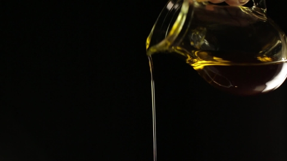 Olive Oil Pouring From The Jug
