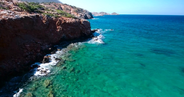 Blue Sea, Waves Breaking In Cliffs At Shore