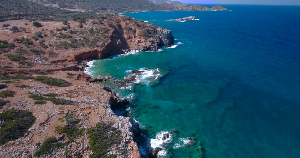 Blue Sea, Waves Breaking In Cliffs At Shore