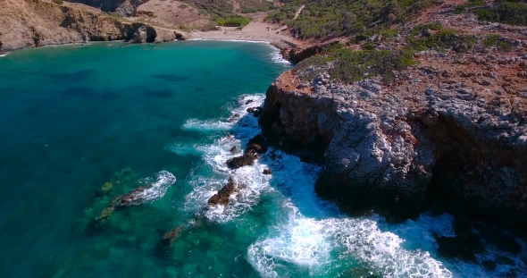 Blue Sea, Waves Breaking In Cliffs At Shore