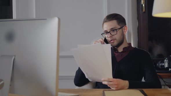 Angry Young Businessman Screaming At Phone In His Office And Throw Documents alt