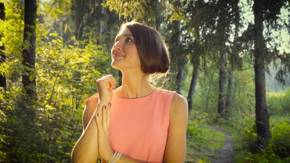 Walking Girl In a Pink Dress In The Woods On a Sunny Day.