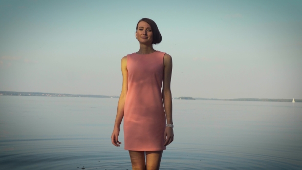 Modest Girl Walking Near The Water Body