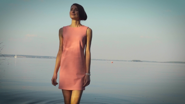 Modest Girl Walking Near The Water Body