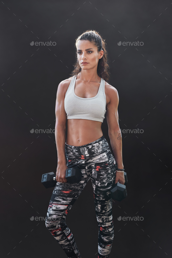 Muscular sportswoman with dumbbells - Stock Photo - Images