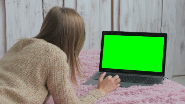 Woman Using Laptop With Green Screen