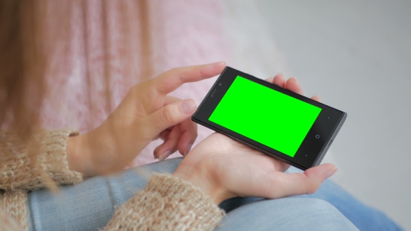 Woman Looking At Smartphone With Green Screen