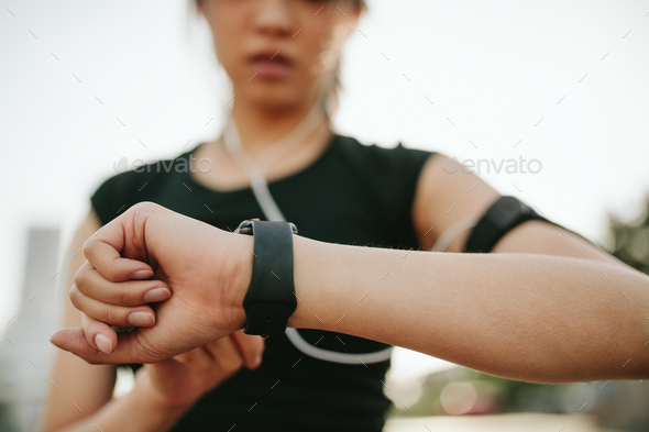 Fitness female monitoring her performance on smartwatch - Stock Photo - Images