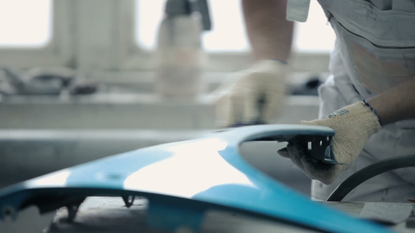 The Worker Polishes The Surface Of The Bumper. alt