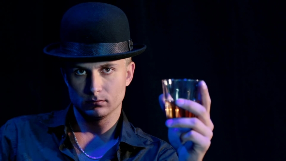 A Man In a Hat With a Black Background