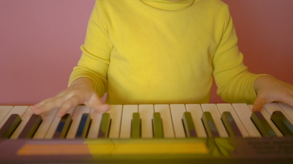 Child Learning To Play The Piano