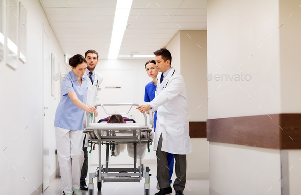 medics with woman on hospital gurney at emergency - Stock Photo - Images