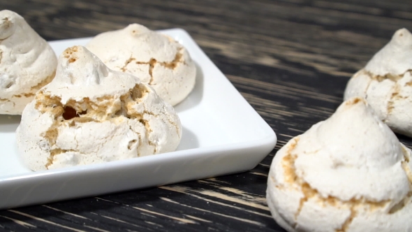 Lot Of White Meringue Cakes With Coffee