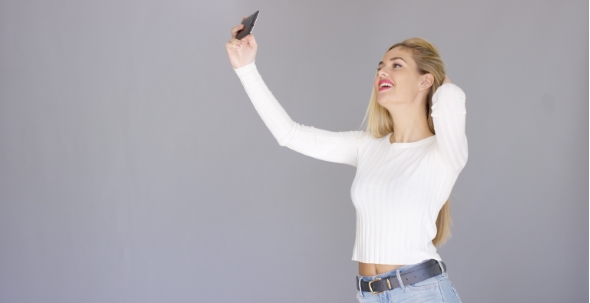 Sexy Young Blond Woman Posing For a Selfie alt