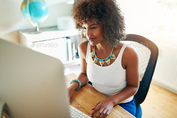 Pretty young woman working on a start up business - Stock Photo - Images