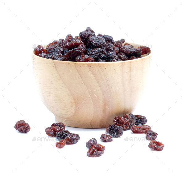 Dried grapes in wood bowl on white background. - Stock Photo - Images