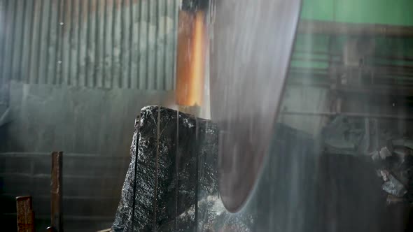 Large Industrial Stone Cutter Cuts Granite Rock Into Plates in Jets of Water Close Up alt
