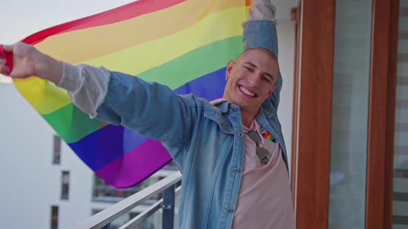 Glamorous Happy Bald Caucasian Gay Man Waving Rainbow Pride Flag and Celebrating Pride Month alt