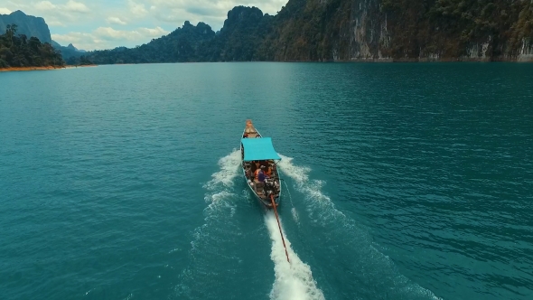 Aerial: Flight Behind a Boat On The Lake. alt