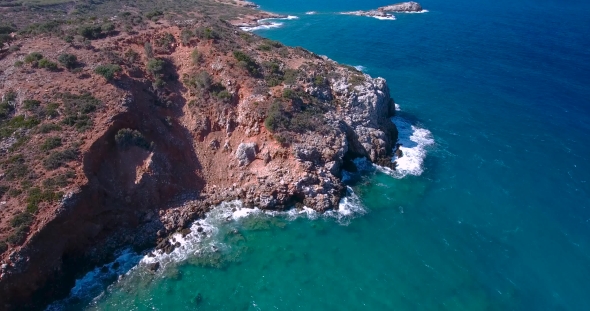 Blue Sea, Waves Breaking In Cliffs At Shore