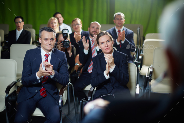 Audience applauding to speaker - Stock Photo - Images
