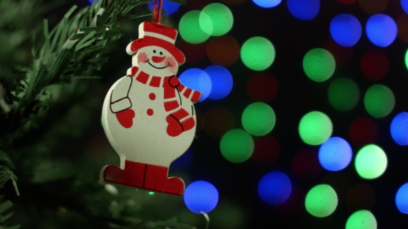 Christmas Background With Christmas Tree And Snowman On Background Of Blurred Lights Garlands alt