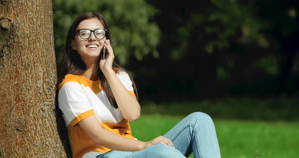 Woman Talking on Smartphone in Park