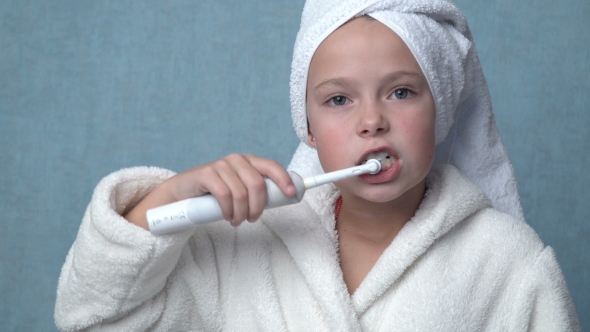 Girl Cleaning Teeth With Electric Toothbrush alt