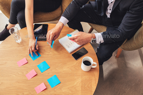 Two business colleagues preparing post it notes - Stock Photo - Images