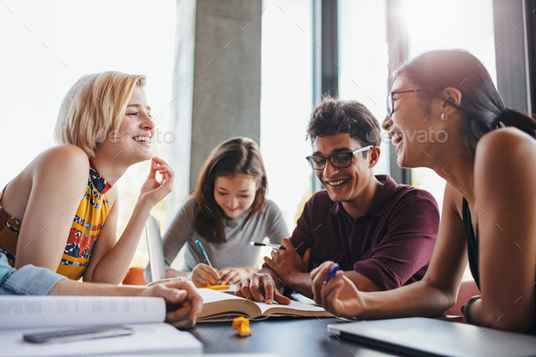Multiethnic young people studying at school library - Stock Photo - Images