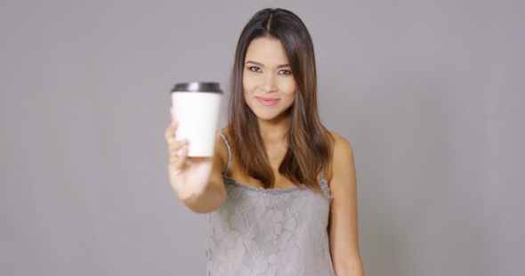 Young Woman Offering a Cup Of Takeaway Coffee alt