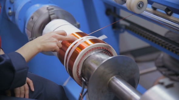 Transformer, Engine Production. Worker Winding Cooper Wires On a High Voltage Transformer. Slider alt