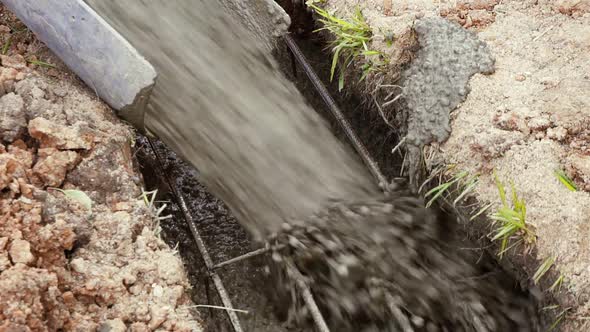 Flowing Cement Closeup on the Foundation of the Cottage During Construction Close Up alt