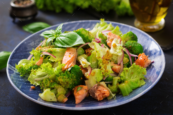 Salad of stewed fish salmon, broccoli, lettuce and dressing.