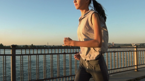 Young Woman Jogging In Sunset