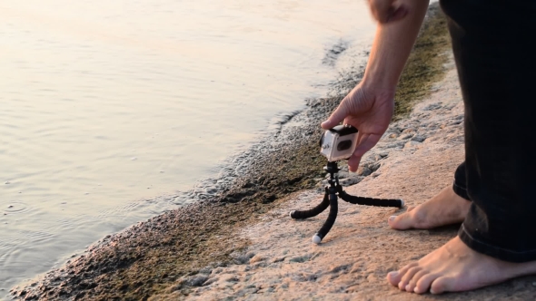 Man Installs Action Camera On Shore